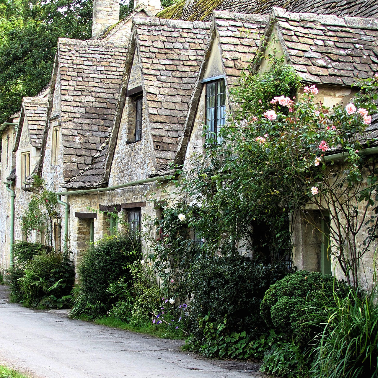 Exterior of attractive terraced cottages in an unnamed, quintessential Cotswold village